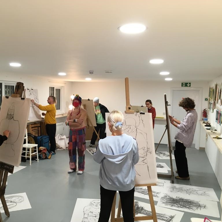 a group of people doing a life drawing session
